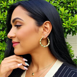 1.5 inch bamboo hoop earrings on a person
