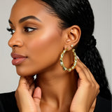 bamboo hoop earrings on a person
