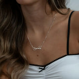 infinity name necklace on a person