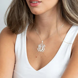 monogram necklace on a person