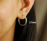 25mm sterling silver hoop earrings on person